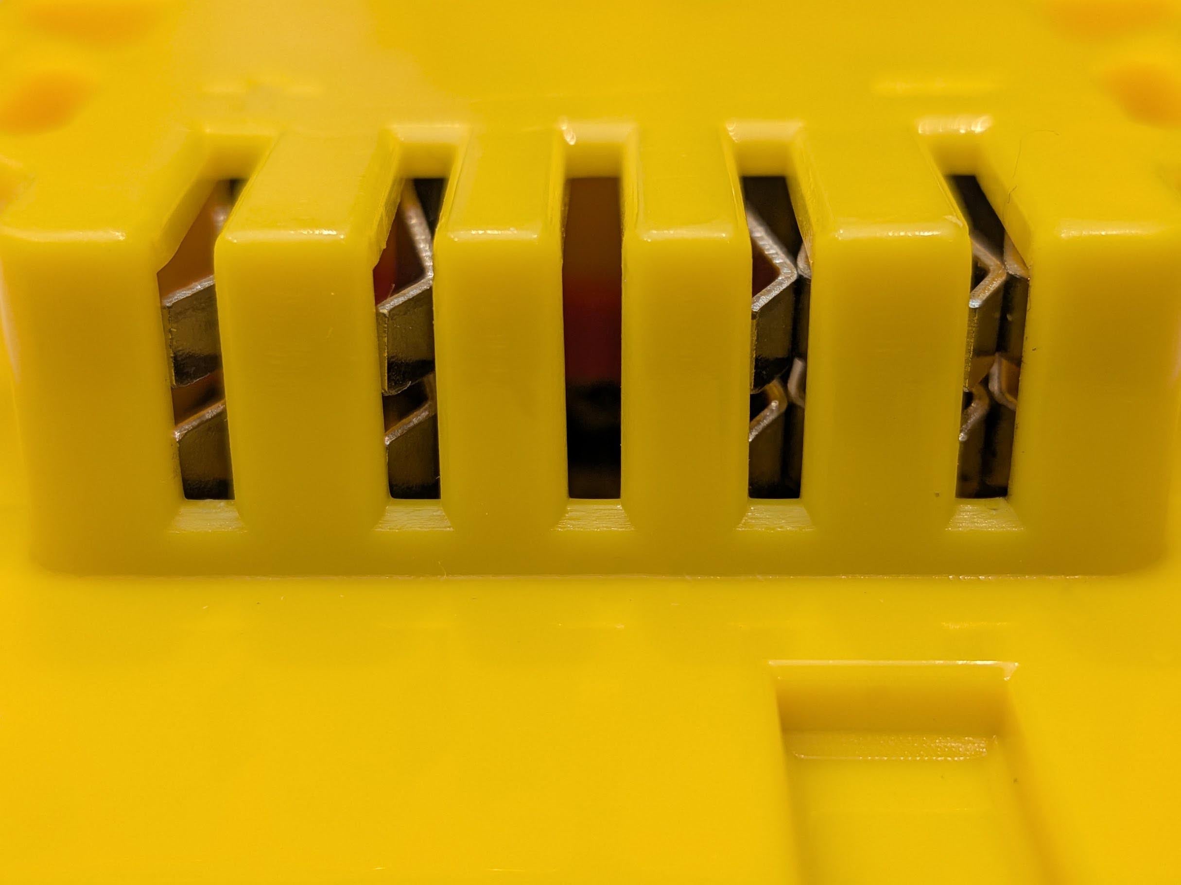 Craftsman 20V to DeWalt 20V MAX battery adapter - close-up of the tool-side terminal slots and their copper contacts