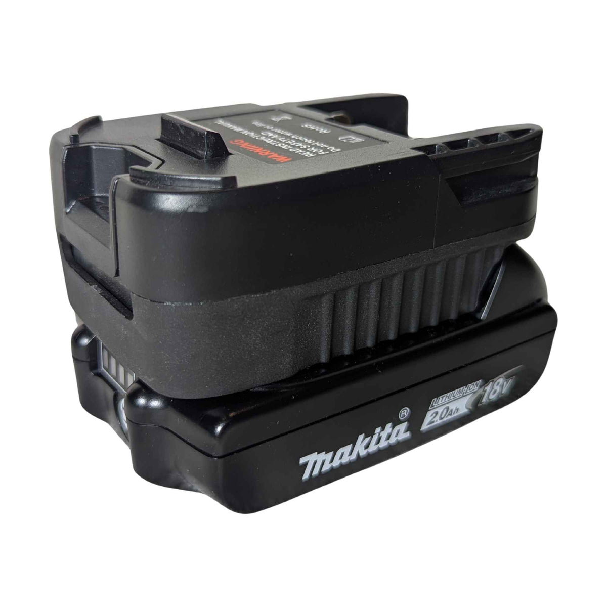 Makita 18V LXT to RIDGID 18V battery adapter - fitted to the Makita 18V LXT battery, vent ribs and warning label in view