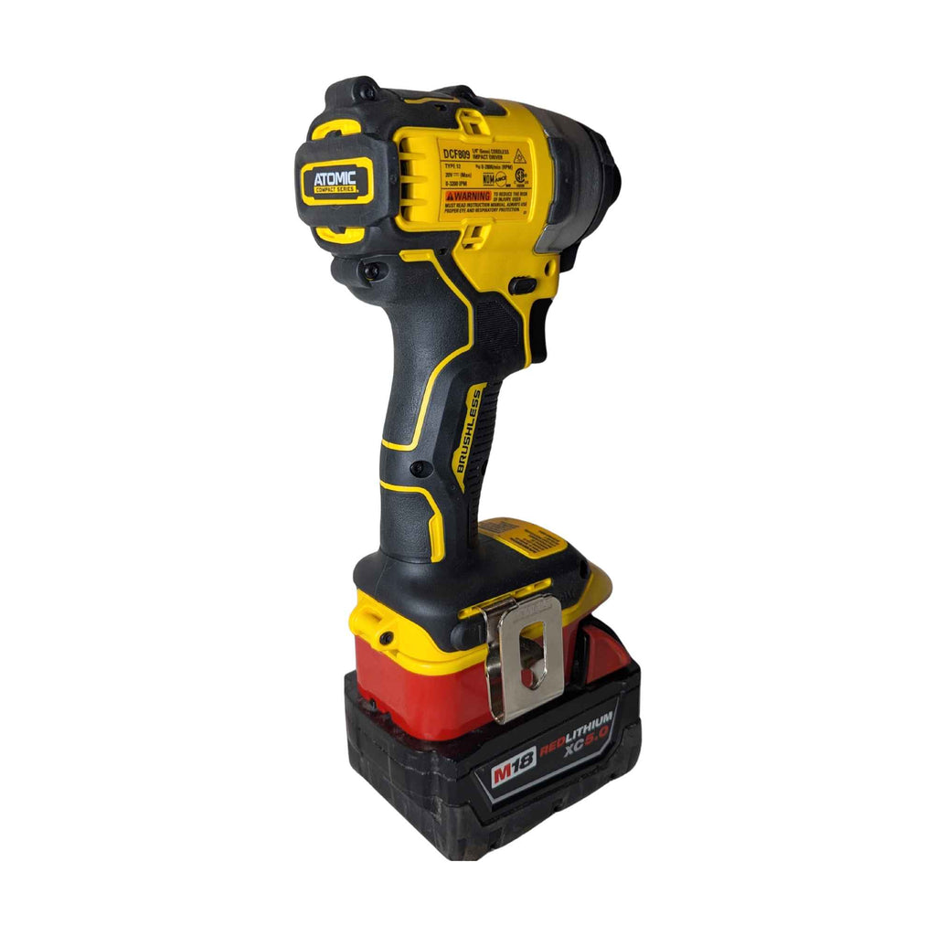 Milwaukee M18 to DeWalt 20V MAX battery adapter - installed on a DeWalt impact driver, rear view with the belt clip